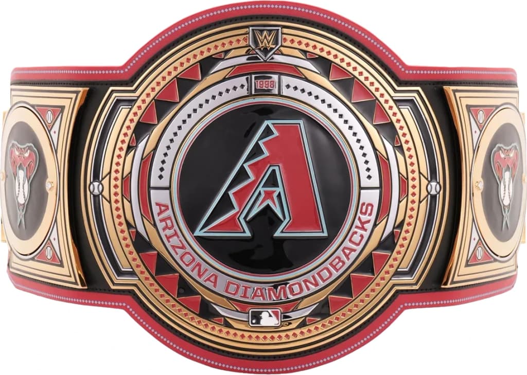 Display-grade replica championship title belt with die-struck metal plates on a full-grain leather strap.