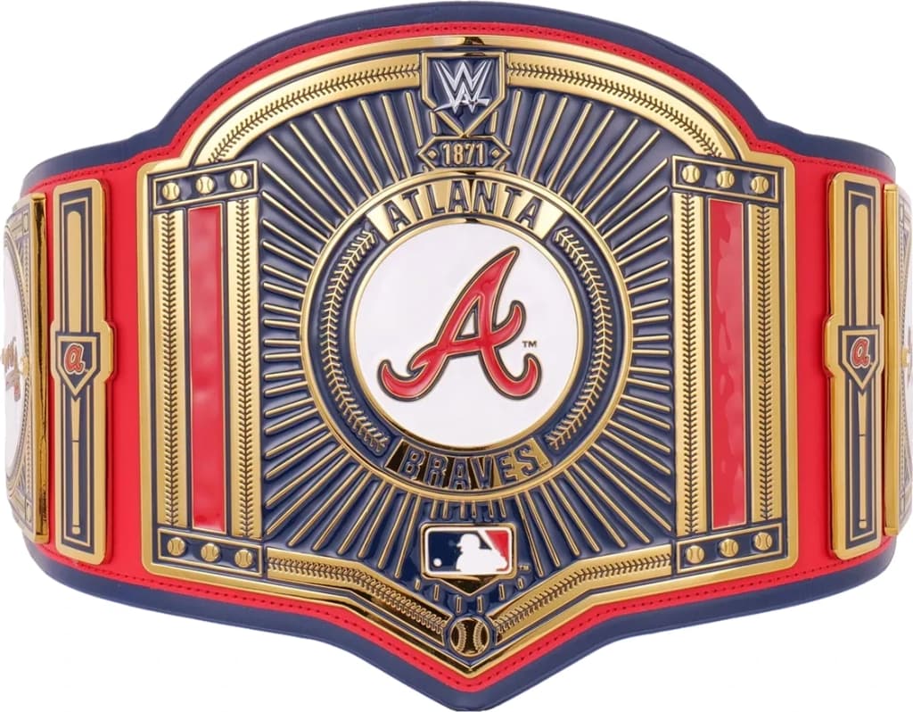 Display-grade replica championship title belt with die-struck metal plates on a full-grain leather strap.