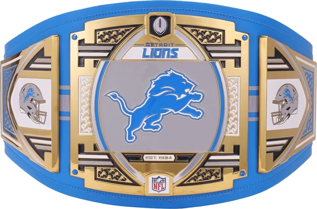 Display-grade replica championship title belt with die-struck metal plates on a full-grain leather strap.