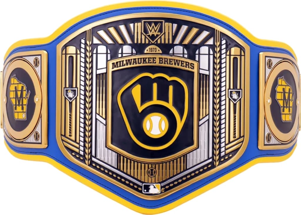Display-grade replica championship title belt with die-struck metal plates on a full-grain leather strap.