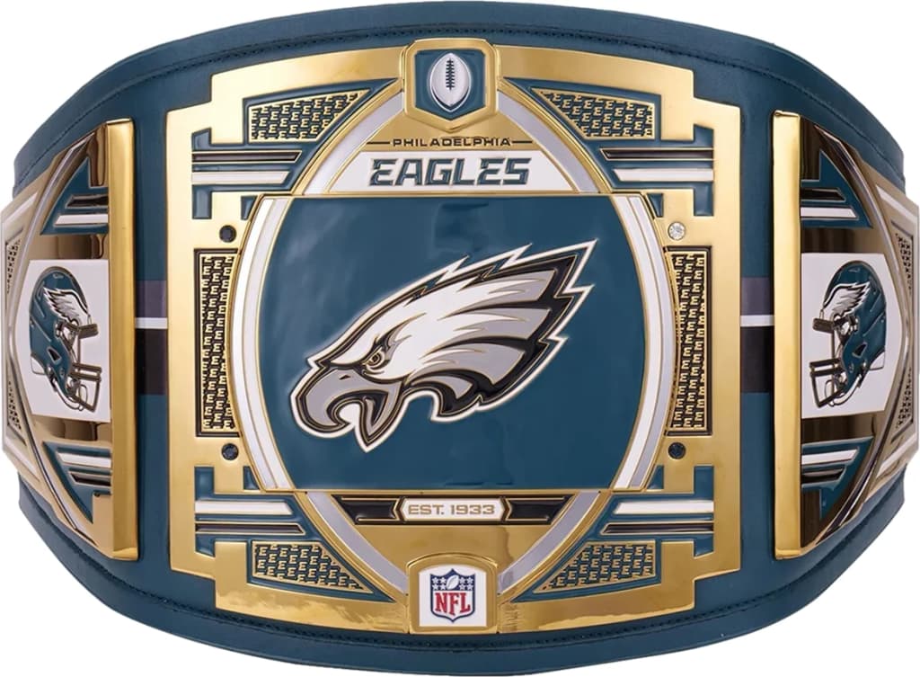 Display-grade replica championship title belt with die-struck metal plates on a full-grain leather strap.